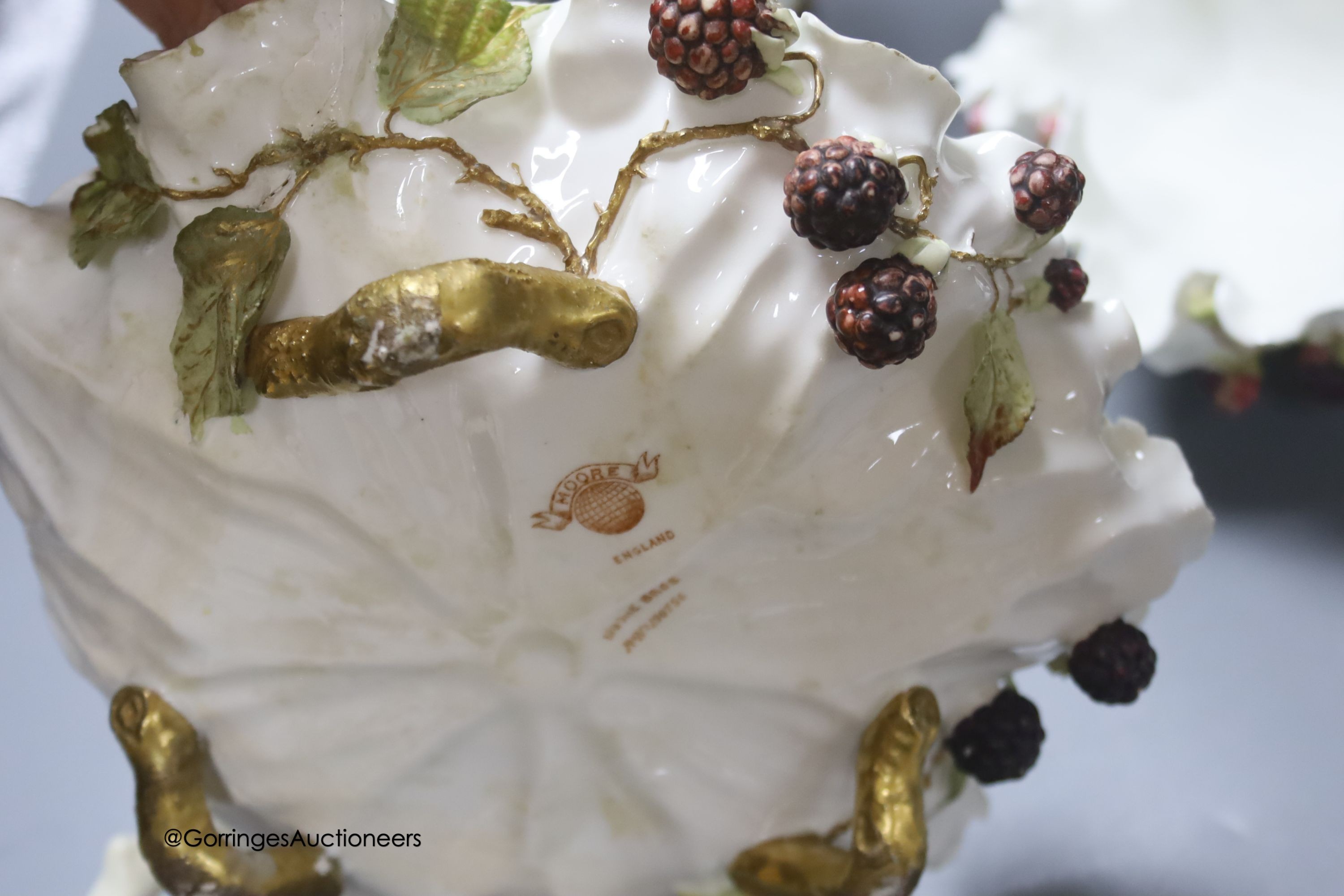 A pair of Moore Bros leaf pattern bowls, encrusted with fruit and surmounted by cherubs and a similar pair of tazza stands, height 24cm